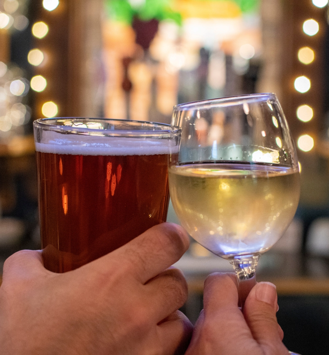 A couple toasting at the bar